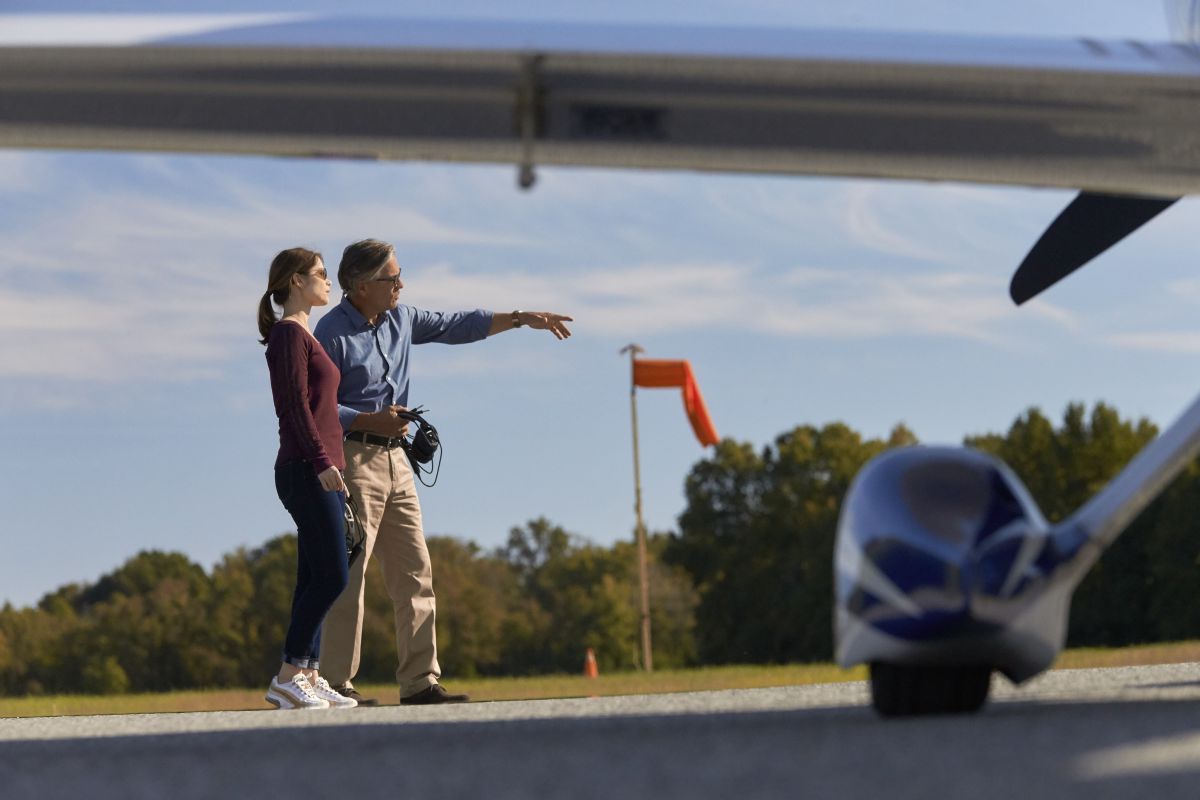 Photography of a young female pilot with another pilot by a Cessna TTx with a windsock.

Essex Skypark (W48)
Baltimore MD USA
